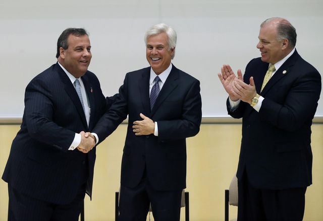 Three middle-aged white men--former New Jersey Governor Chris Christie on the left, South Jersey party boss George Norcross in the center, and New Jersey Senate President Stephen Sweeney on the right--at an event.